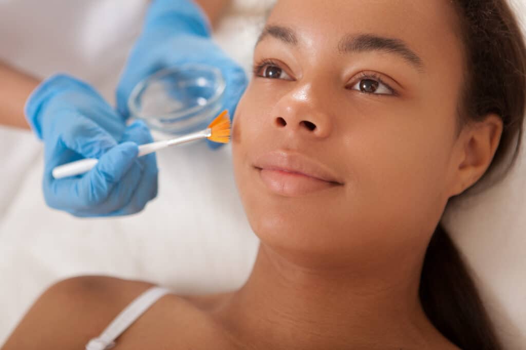 a photo of a woman getting a facial peel