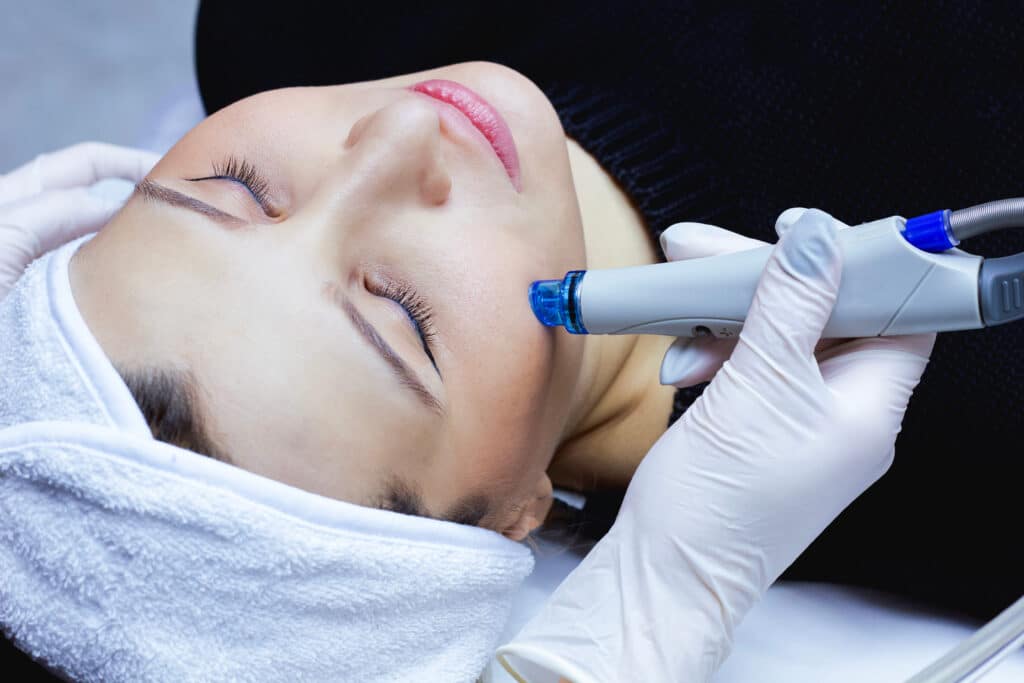 a photo of a woman getting a hydrafacial